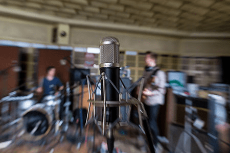 Inside a recording studio, close up of a microphone