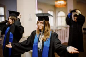 A BIMM Berlin Graduation student with her arms out