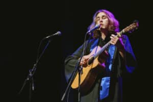Julian Brown on stage with a guitar at the BIMM Berlin graduation 2022