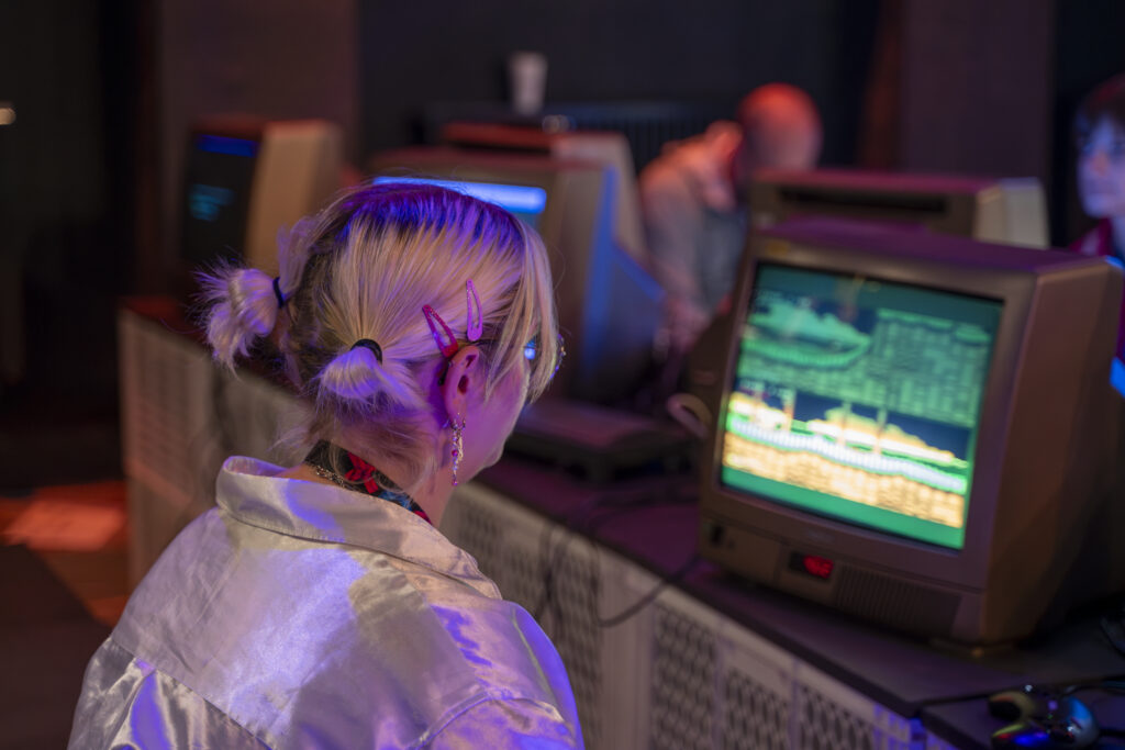 Student plays a retro video game at Games Ground Berlin