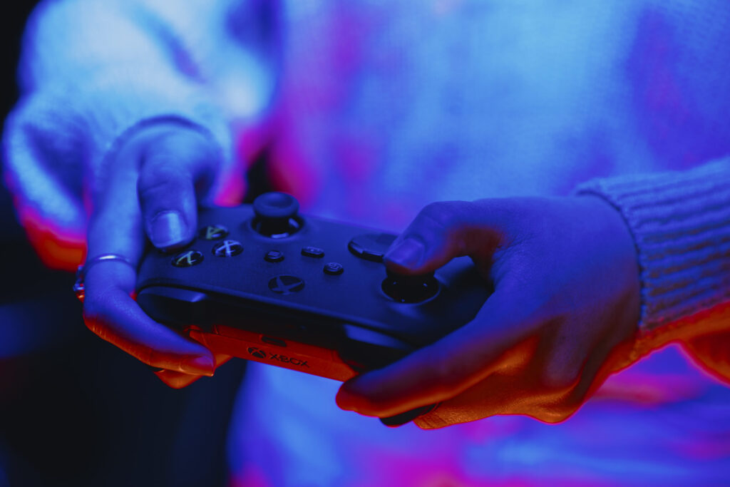 A student holding a XBOX One controller