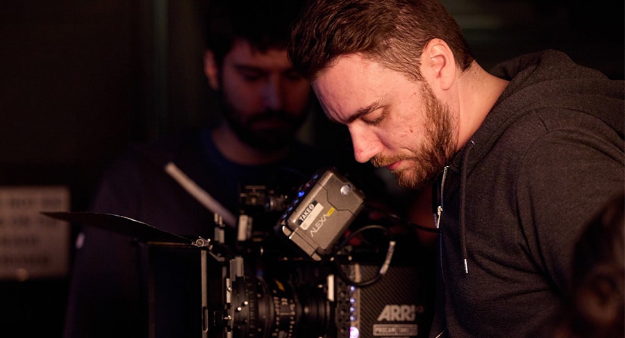 Man looking into the lens of a camera